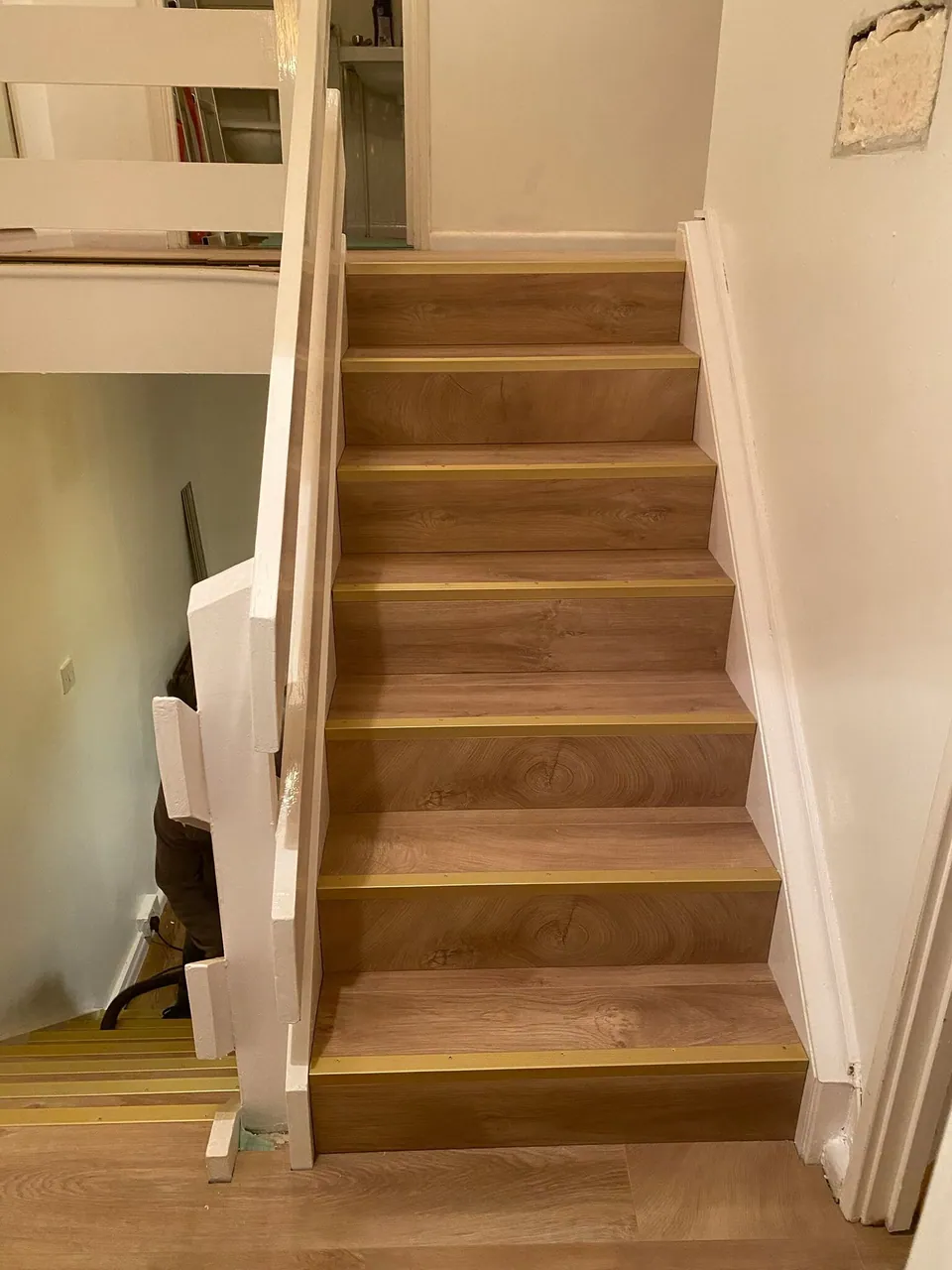 Refurbished staircase with oak-effect treads, white painted risers and strings, fitted by Basingstoke Bathrooms